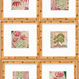 May include: Six framed art prints with bamboo-style gold frames. Each print features a different watercolor design with pink flowers, green leaves, and geometric patterns on a cream background. The prints are displayed against a warm brown background.
