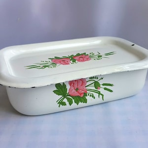 May include: White enamel baking dish with a floral design featuring pink flowers and green leaves.