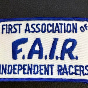 May include: Blue and white embroidered patch with the text "First Association of F.A.I.R. Independent Racers".