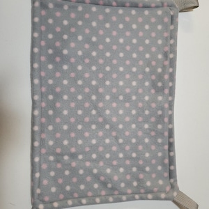 May include: A gray and pink polka dot fleece hammock for small pets. The hammock has four loops for hanging.