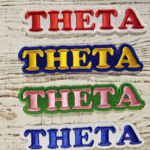 May include: Four embroidered patches with the word "THETA" in different colors. The patches are red, yellow, green, and blue.