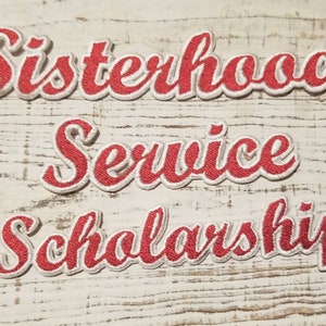 May include: Three red embroidered patches with white outlines. The patches read "Sisterhood", "Service", and "Scholarship".