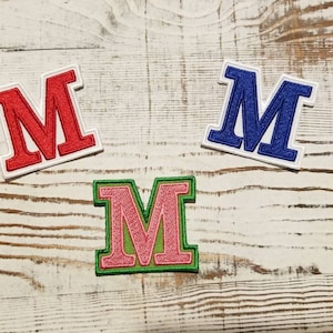 griechischer Buchstabe Mu; Bügelbild; Schwesternschaft, Brüderlichkeit