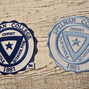 May include: Two white embroidered patches with blue lettering and a blue triangle with a star inside. The text reads "Spelman College" and "Christ Our Whole School For 1881".