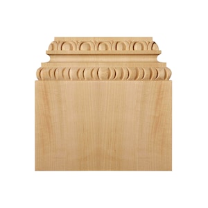 May include: A natural wood decorative molding with a detailed carved design. The molding has a square base and a decorative top with a repeating pattern of rounded shapes.