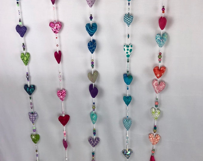 Pretty beaded and bejewelled Suncatchers, puffy strings of hearts and beads with a tassel tail.