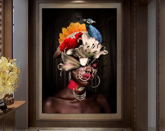 May include: A framed portrait of a person with dark skin, adorned with a vibrant headdress featuring a peacock, flowers, and feathers. The person wears a red choker, gold jewelry, and large hoop earrings. The background is a dark forest.