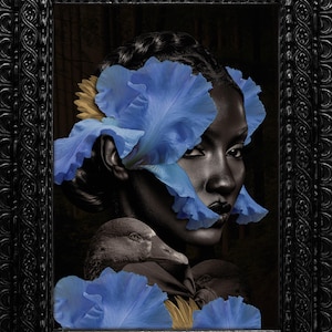 May include: A framed artwork featuring a woman's face adorned with blue iris petals and a yellow flower. The artwork also includes a depiction of a duck. The frame is black with ornate detailing, creating a striking contrast.