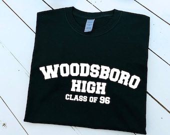 Pode incluir: Camiseta preta com texto branco que diz "Woodsboro High Class of 96".