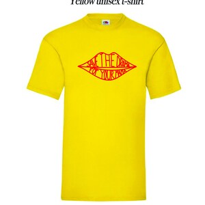 May include: Yellow unisex t-shirt with a red outline of a pair of lips that says "Save the drama for your mama".