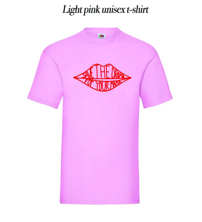 May include: Light pink unisex t-shirt with a red graphic of a pair of lips with the text "Save the drama for your mama" inside.