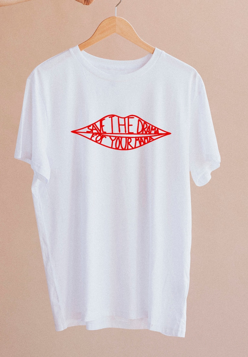 May include: White t-shirt with a red outline of lips that says "Save the drama for your mama".