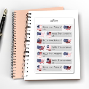 May include: A white sticker sheet with multiple stickers featuring the Arizona state outline and the American flag. Each sticker has the text "Hello from Arizona!" and space for a US address.