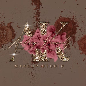 May include: Gold glitter letters "AK" with a pink cloud behind them. The letters are outlined in gold. The text "Audrey Kennedy Makeup Studio" is below the letters.