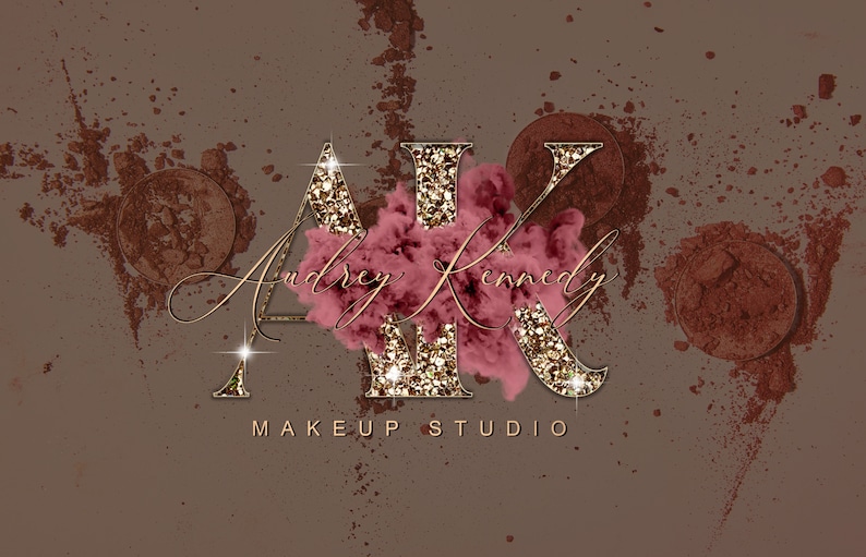 May include: Gold glitter letters "AK" with a pink cloud behind them. The letters are outlined in gold. The text "Audrey Kennedy Makeup Studio" is below the letters.