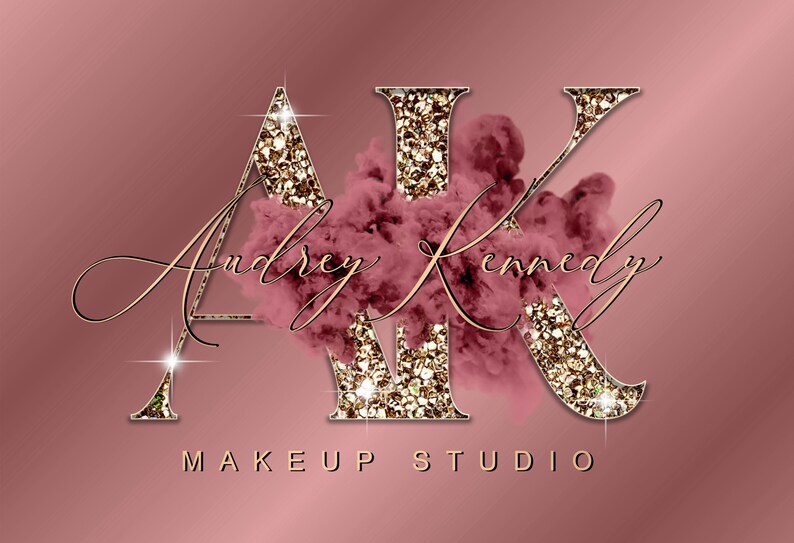 May include: Gold glitter letters "AK" with a pink and gold glitter cloud behind them. The text "Audrey Kennedy Makeup Studio" is written in cursive below the letters.