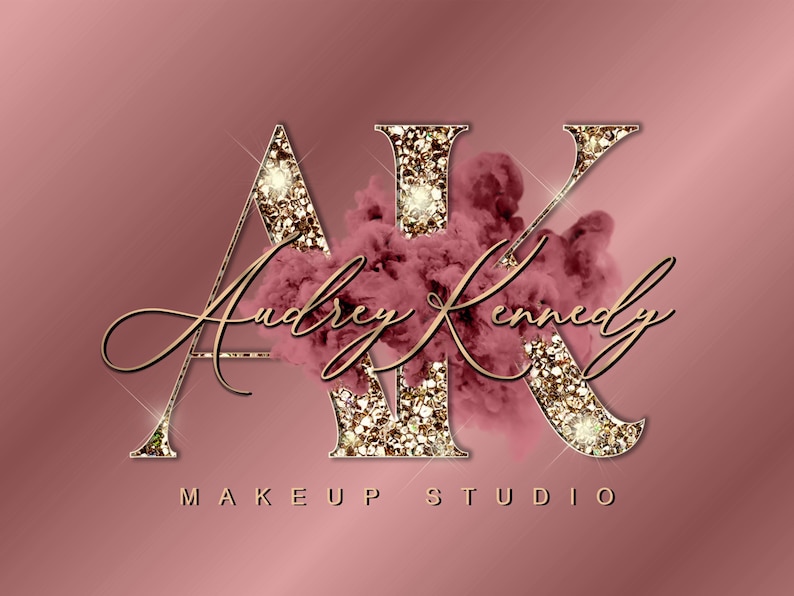 May include: Gold glitter letters "AK" with a pink smoke effect behind them. The text "Audrey Kennedy Makeup Studio" is written in cursive below the letters.