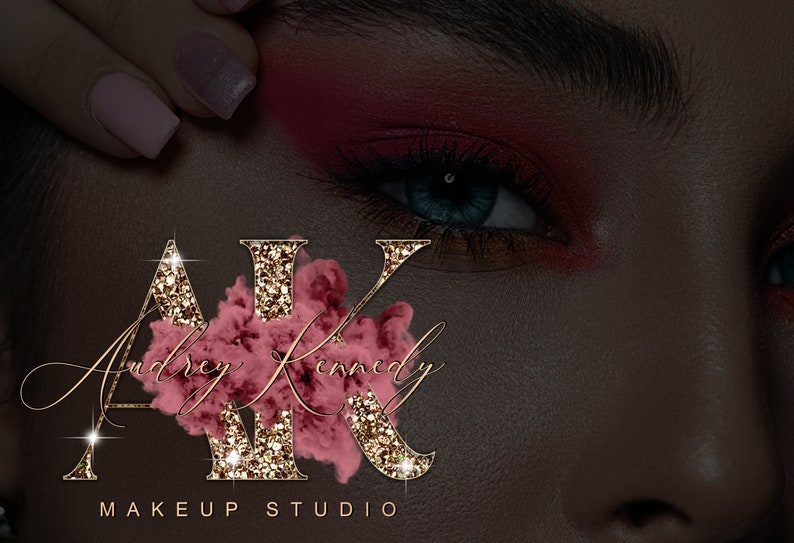May include: Gold glitter letters "AK" with a pink watercolor design behind them. The letters are surrounded by sparkling lights. The text "Audrey Kennedy Makeup Studio" is below the letters.