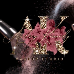 May include: Gold glitter letters "AK" with a pink and gold makeup powder cloud behind them. The text "Audrey Kennedy Makeup Studio" is below the letters.