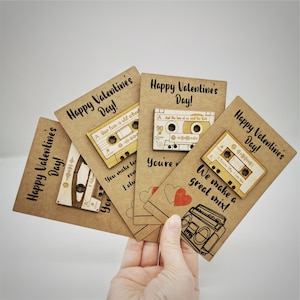May include: Four brown cardstock Valentine's Day cards with a cassette tape design. The cards feature the text "Happy Valentine's Day!" and various messages about love.