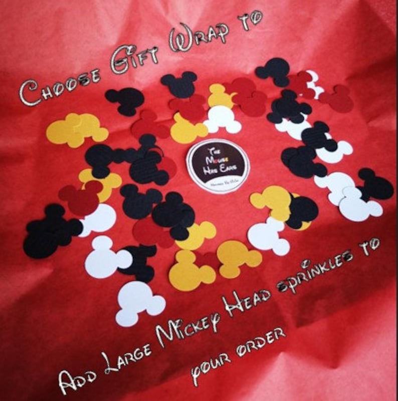 May include: Red, yellow, black, and white Mickey Mouse head confetti on a red background. The text "CHOOSE GIFT WRAP TO" and "ADD LARGE MICKEY HEAD SPRINKLES TO YOUR ORDER" is written on the background.