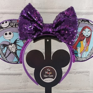 May include: Purple sequin bow headband with Nightmare Before Christmas themed ears. One ear features Jack Skellington and the other features Sally.