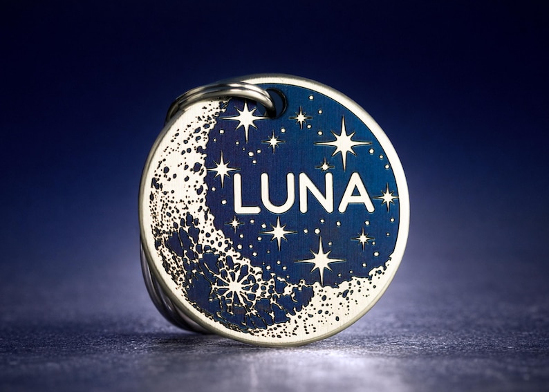 Custom engraved pet ID tag, moon and stars design, black or blue celestial dog name tag, personalised cat name tag, stainless steel round tag. Unique