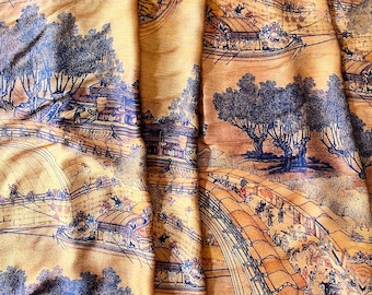 May include: Close-up of a fabric with a detailed Asian-inspired landscape design. The fabric features a golden-yellow base with a repeating pattern of bridges, boats, trees, and figures in shades of blue and brown.