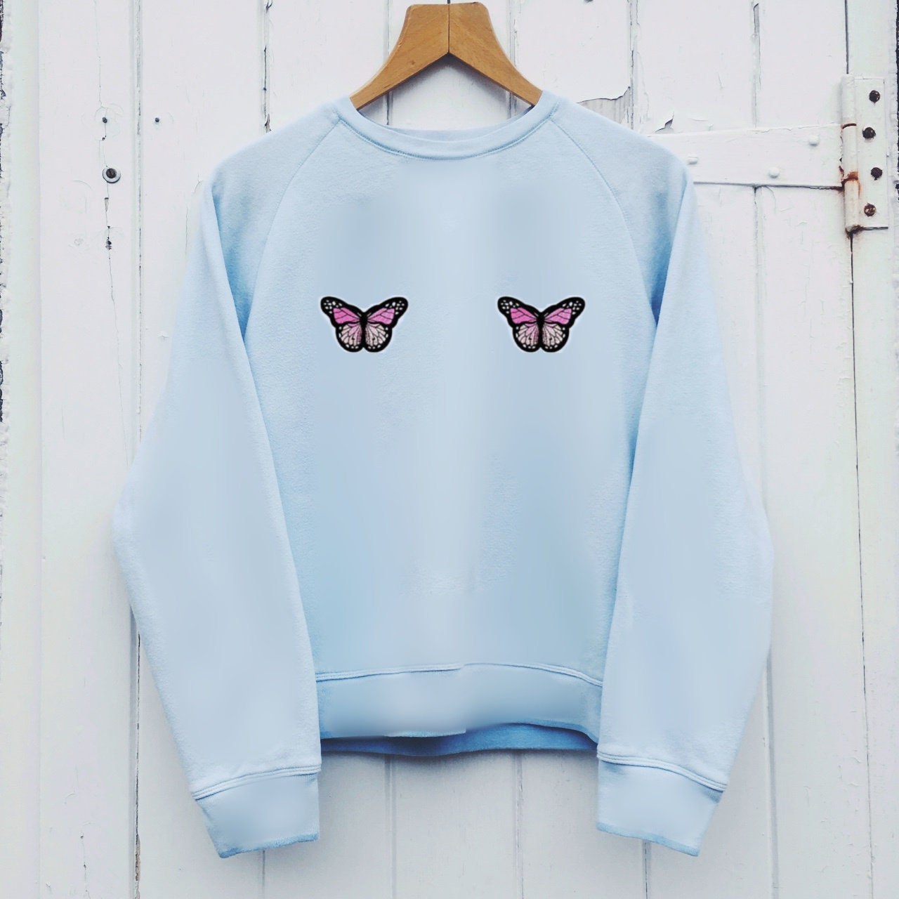 white sweater with blue butterfly