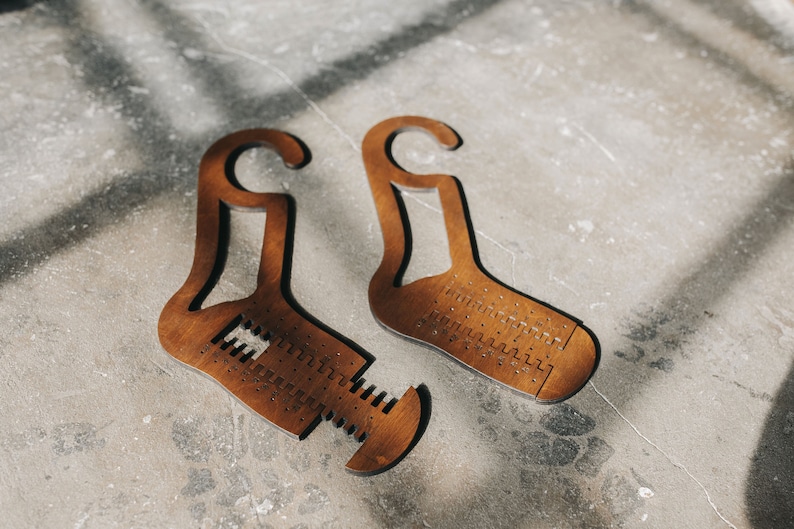 May include: Two wooden shoe shapers with a hook at the top. The shapers are designed to help maintain the shape of shoes.