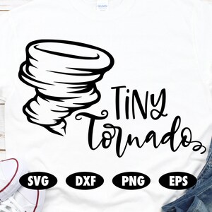 May include: White t-shirt with a black graphic of a tornado and the words "Tiny Tornado" in a handwritten font. Below the text are the file format icons: SVG, DXF, PNG, and EPS.