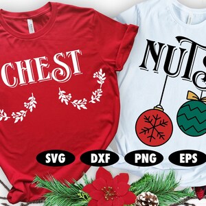 May include: Two red and white Christmas themed t-shirts. The first shirt says "CHEST" with white holly leaves on either side. The second shirt says "NUTS" with two hanging ornaments, one red with a snowflake and one green with a wavy pattern.