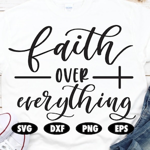 May include: White t-shirt with black text that reads "faith over everything". The shirt is laying on a wooden surface with a pair of white sneakers and blue jeans in the background. The text is in a cursive font. The image also includes the words "SVG", "DXF", "PNG", and "EPS" in black circles.