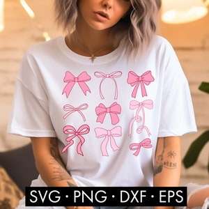 May include: A white t-shirt with a design of pink bows in various styles. The bows are outlined in a darker pink and are arranged in a grid pattern.