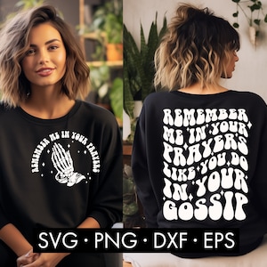 May include: Black sweatshirt with white text that reads "Remember me in your prayers like you do in your gossip". The text is in a retro, psychedelic font. The sweatshirt is being modeled by a person with long, wavy hair.