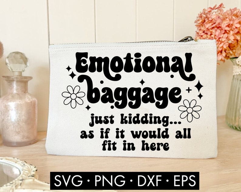 May include: White canvas makeup bag with black text that reads "Emotional baggage just kidding... as if it would all fit in here". The text is in a retro font style. There are two black and white flower illustrations on the bag.