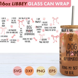 May include: A clear 16oz Libbey glass can wrap with a wooden lid and a stainless steel straw. The glass features pink dog-themed affirmations and graphics, including paw prints and bows. The text reads "Dog Mom Affirmations."