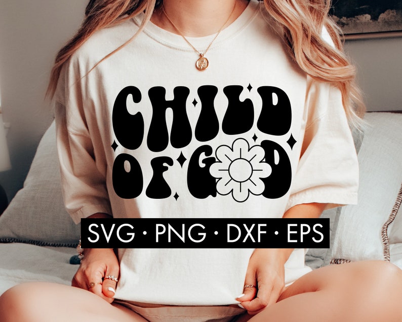May include: A white t-shirt with a black graphic that says "CHILD OF GOD" in a retro font. The graphic also includes a stylized flower with a yellow center.