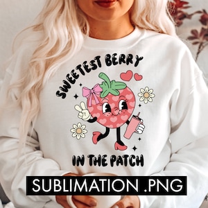 May include: White sweatshirt with a pink strawberry graphic and the text "Sweetest Berry in the Patch".
