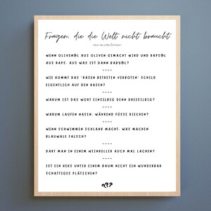 May include: A white framed poster with black text that reads "Fragen, die die Welt nicht braucht" and lists a series of questions.