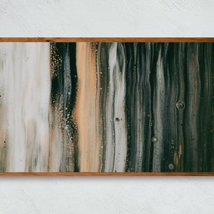 May include: Abstract painting with vertical stripes of white, beige, brown, and green paint. The painting is framed in a natural wood frame.