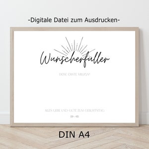 May include: A printable poster with the text "Wunscherfuller" in black cursive font, with a sunburst design above the text. The text "Done erste Million" is below the main text. The text "Alles Liebe und Gute zum Geburtstag" is at the bottom of the poster. The poster is framed in a light wood frame.