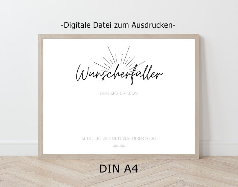 May include: A printable poster with the text "Wunscherfuller" in black cursive font, with a sunburst design above the text. The text "Done erste Million" is below the main text. The text "Alles Liebe und Gute zum Geburtstag" is at the bottom of the poster. The poster is framed in a light wood frame.