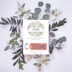 May include: A white card with a floral design and the name "Sandro" written in black script. The card has a 10 Euro bill with the text "1000000" printed on it. The card is surrounded by green leaves.