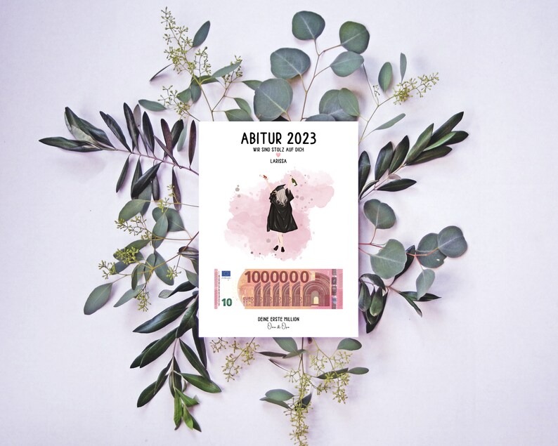 May include: A pink and white card with the text "Abitur 2023" and "Wir sind stolz auf dich Larissa". A cartoon illustration of a person wearing a graduation cap and gown is on the card. A 10 Euro bill with the text "Deine erste Million" is at the bottom of the card.
