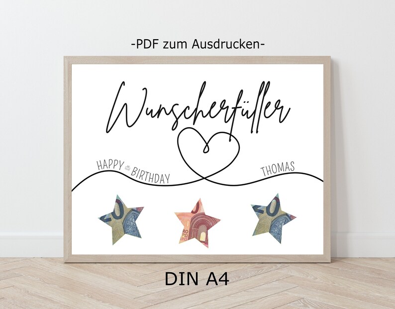 Könnte beinhalten: Druckbarer PDF für ein Geburtstagsgeschenk mit Geld. Das Design zeigt ein Herz mit dem Text "Wunschertüller" darüber und "Happy Birthday" und "Thomas" auf beiden Seiten des Herzens. Drei Sterne aus gefaltetem Geld befinden sich unter dem Herzen.