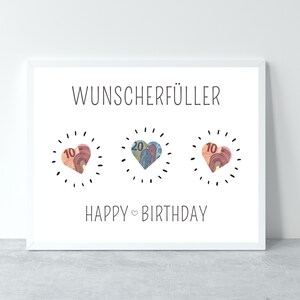 Puede incluir: Tarjeta blanca con el texto "Wunsch erf&uuml;ller" y "Happy Birthday" con tres corazones hechos de billetes. Los corazones est&aacute;n rodeados por un c&iacute;rculo punteado.
