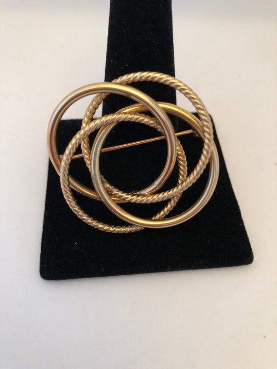 Infinity brooch deals