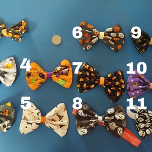 May include: Eleven Halloween-themed bow ties in various colours and patterns, including candy corn, pumpkins, ghosts, and bats. The bow ties are numbered 1 through 11.