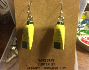 Novelty Earrings: Skin Lotion? Keep away from water--label will probably peel off.